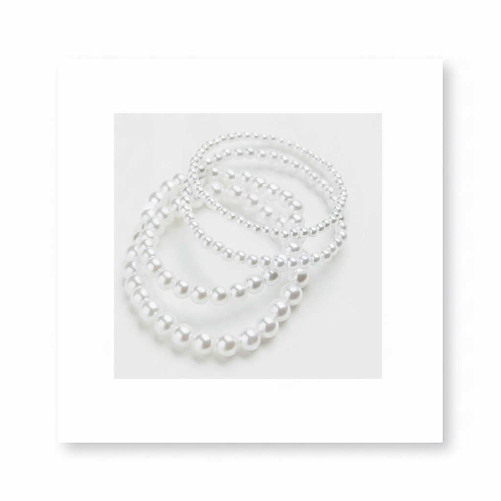 H&M 4 Pack Beaded Bracelets – Close-up of stacked white pearl bracelets on white background