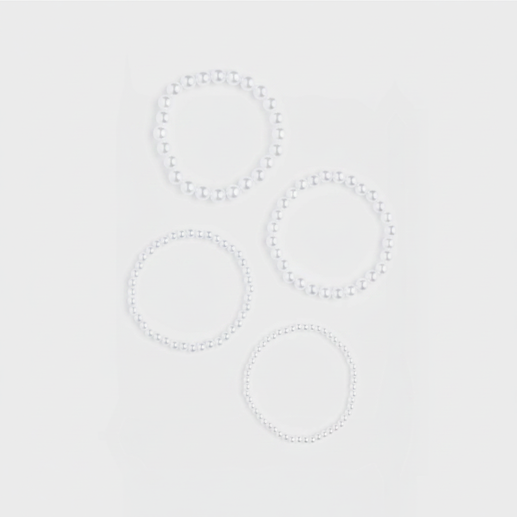 H&M 4 Pack Beaded Bracelets – Flat lay of all 4 white pearl bracelets on white background